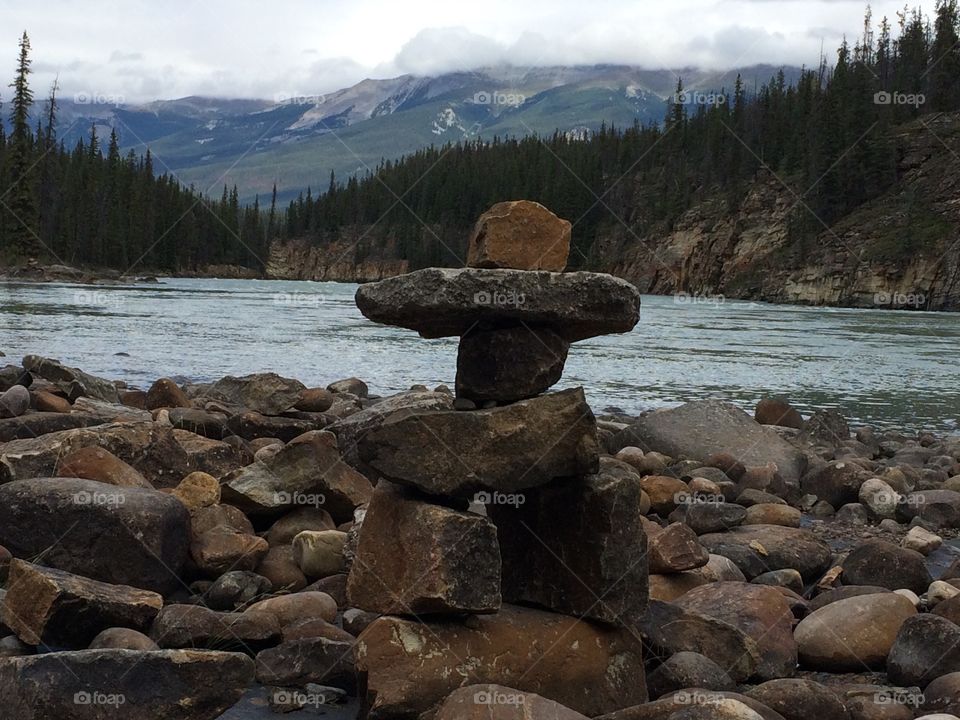 Cool stone man behind river
