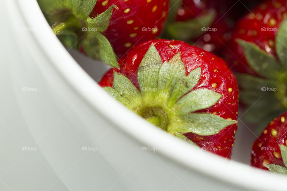 Strawberry close-up view. On white dish