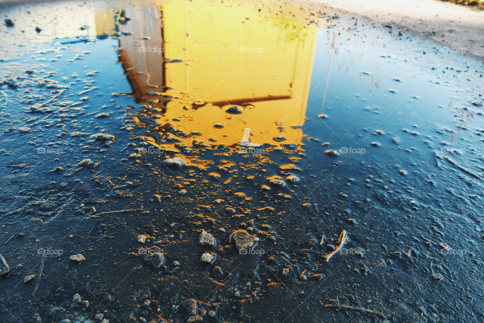 Reflection of a building in a puddle