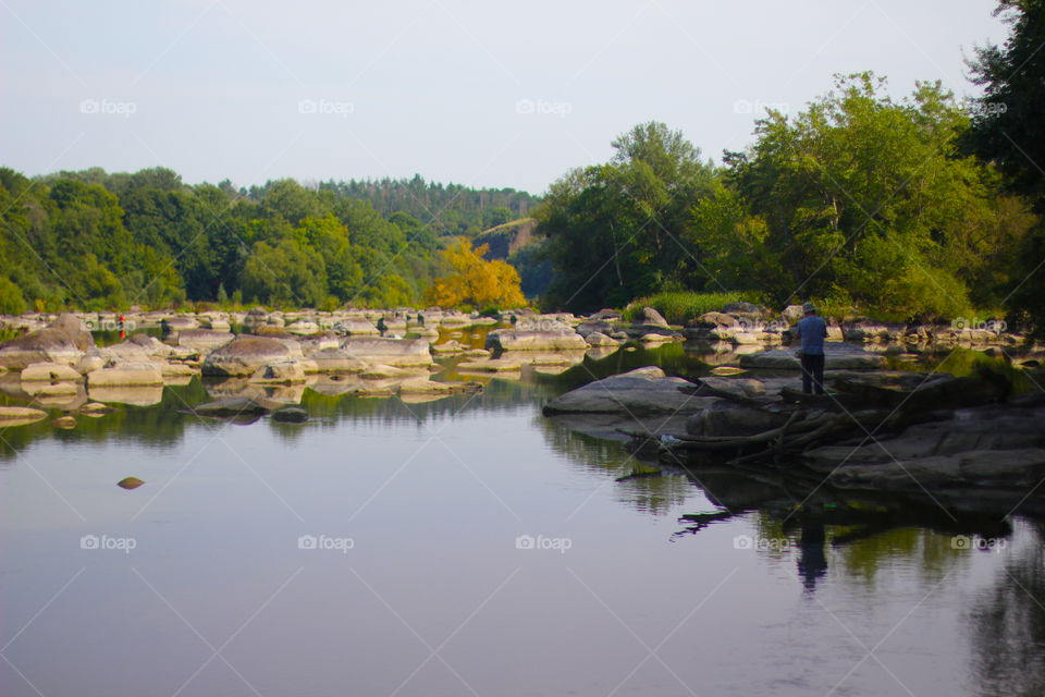 Fisherman on the river’s stone