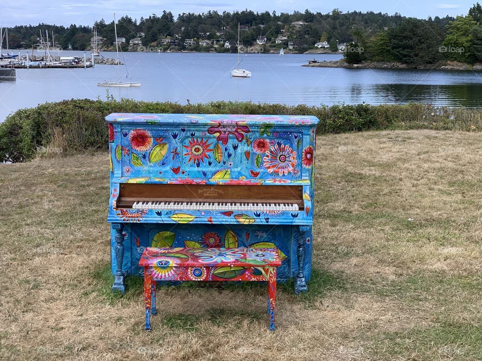 Colourful piano by the ocean, waiting to be played 