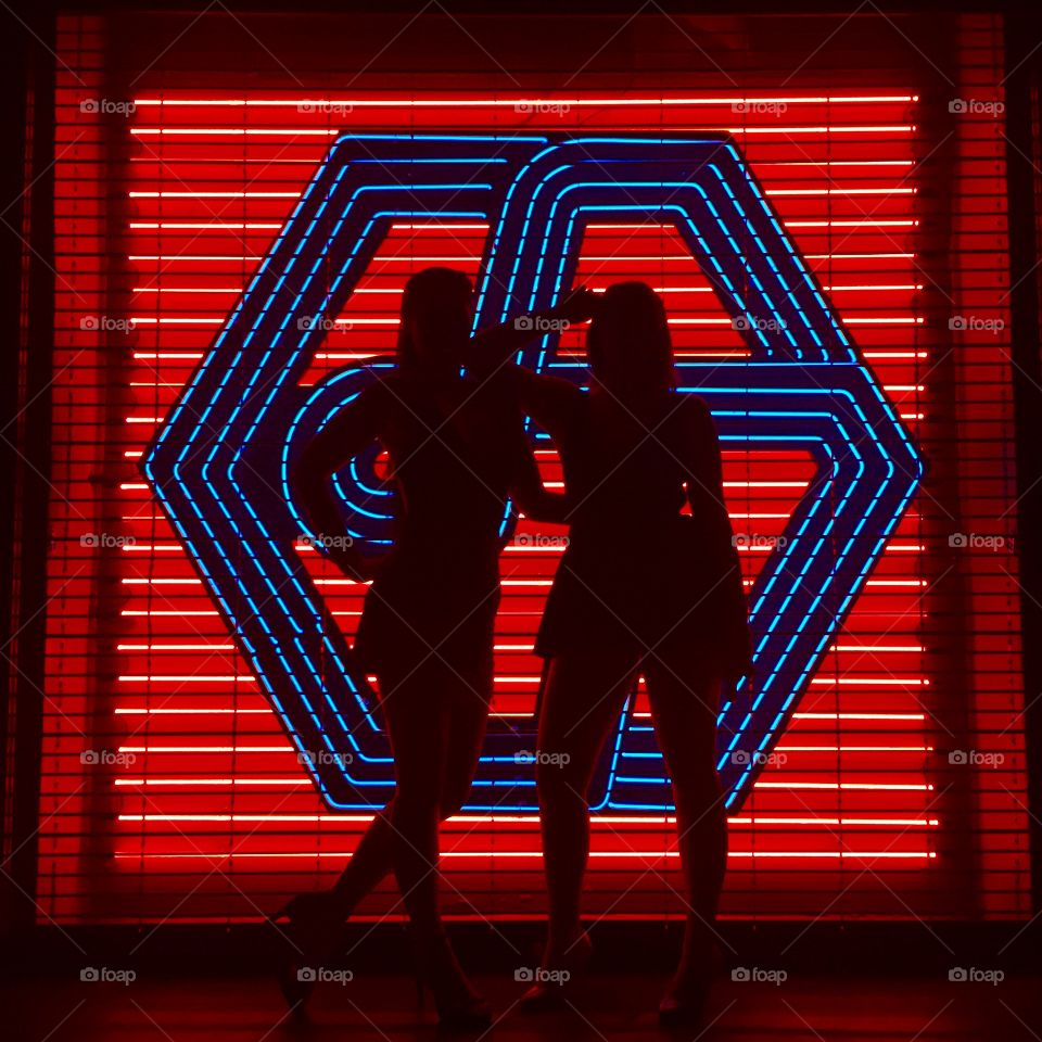 Abstract photo of two girls at a bar Neon sign