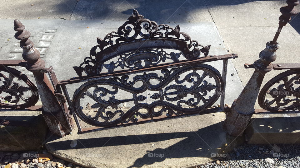 vintage iron scroll work gate for an abandoned gravesite at the Santa Clara Mission cemetery