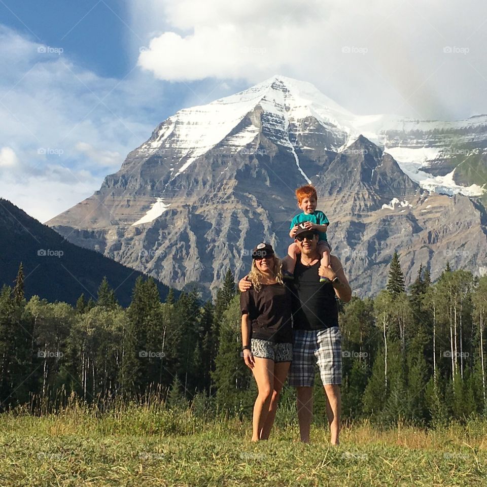 Family in front of beautiful Alberta mountains. 