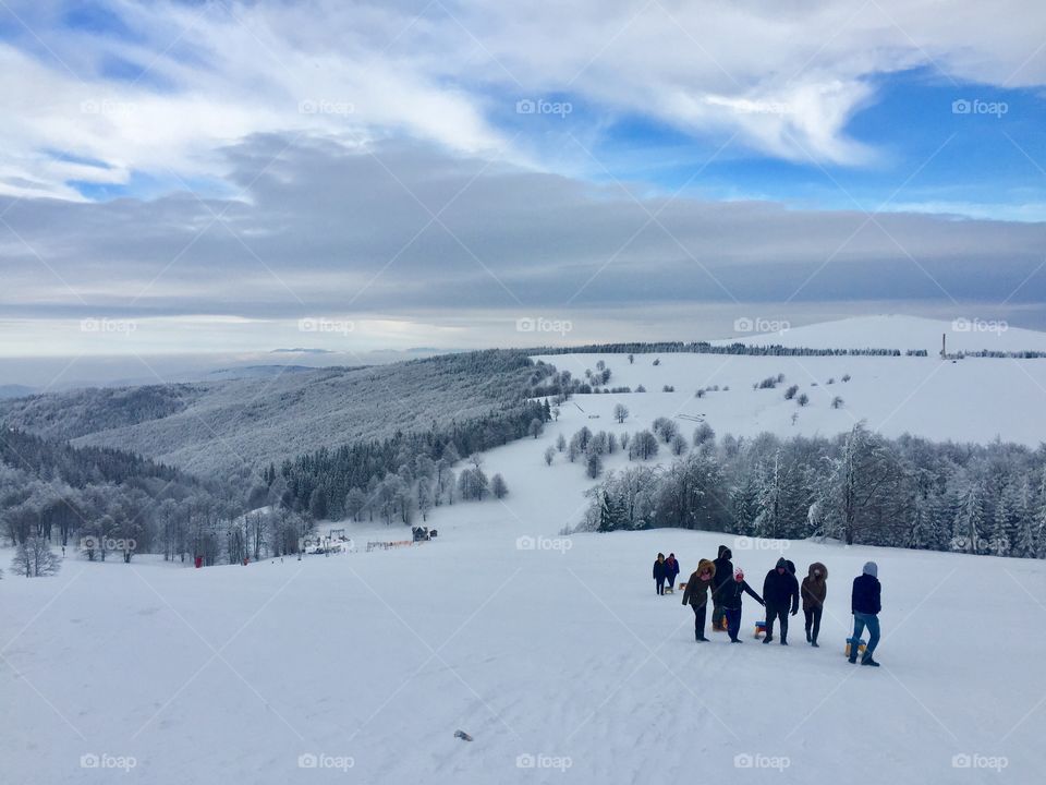 People with sleigh in the mountains