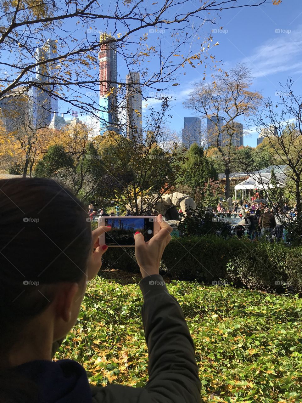 Tourist in central park taking photo