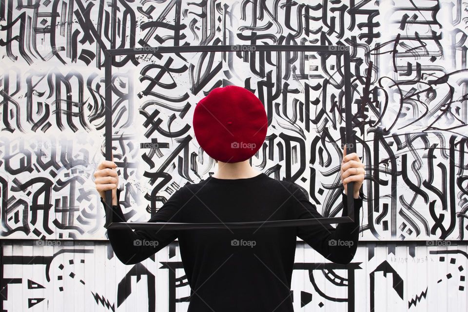 a girl with a beret on her face on a black and white background
