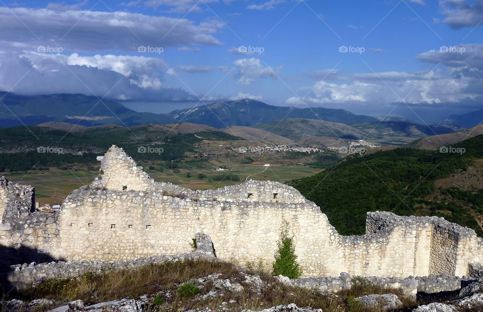 View of stone wall in front of mountain