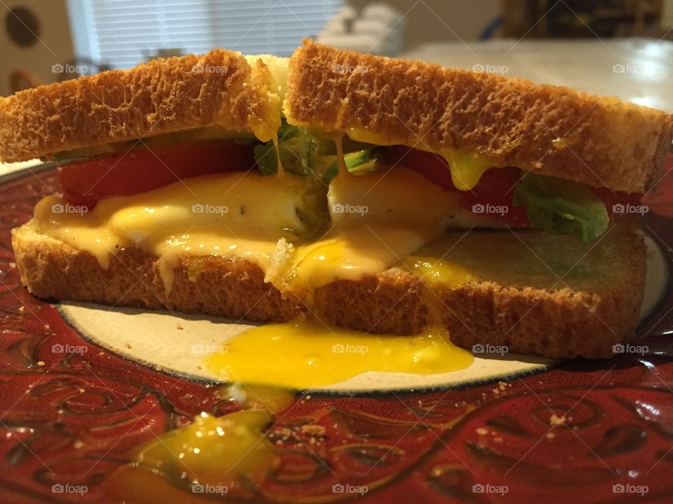 Runny egg yolk sammy. Sunny side up egg, avocado, tomato, & american cheese. 