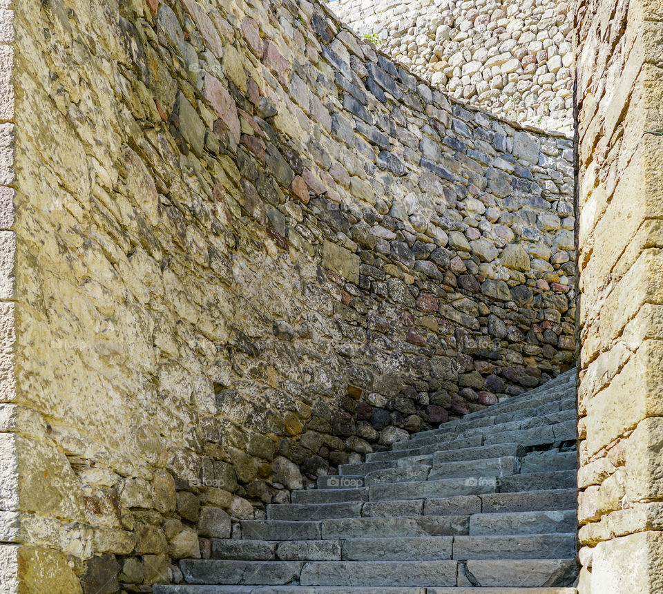 ancient stone wall, winding stone staircase upstairs