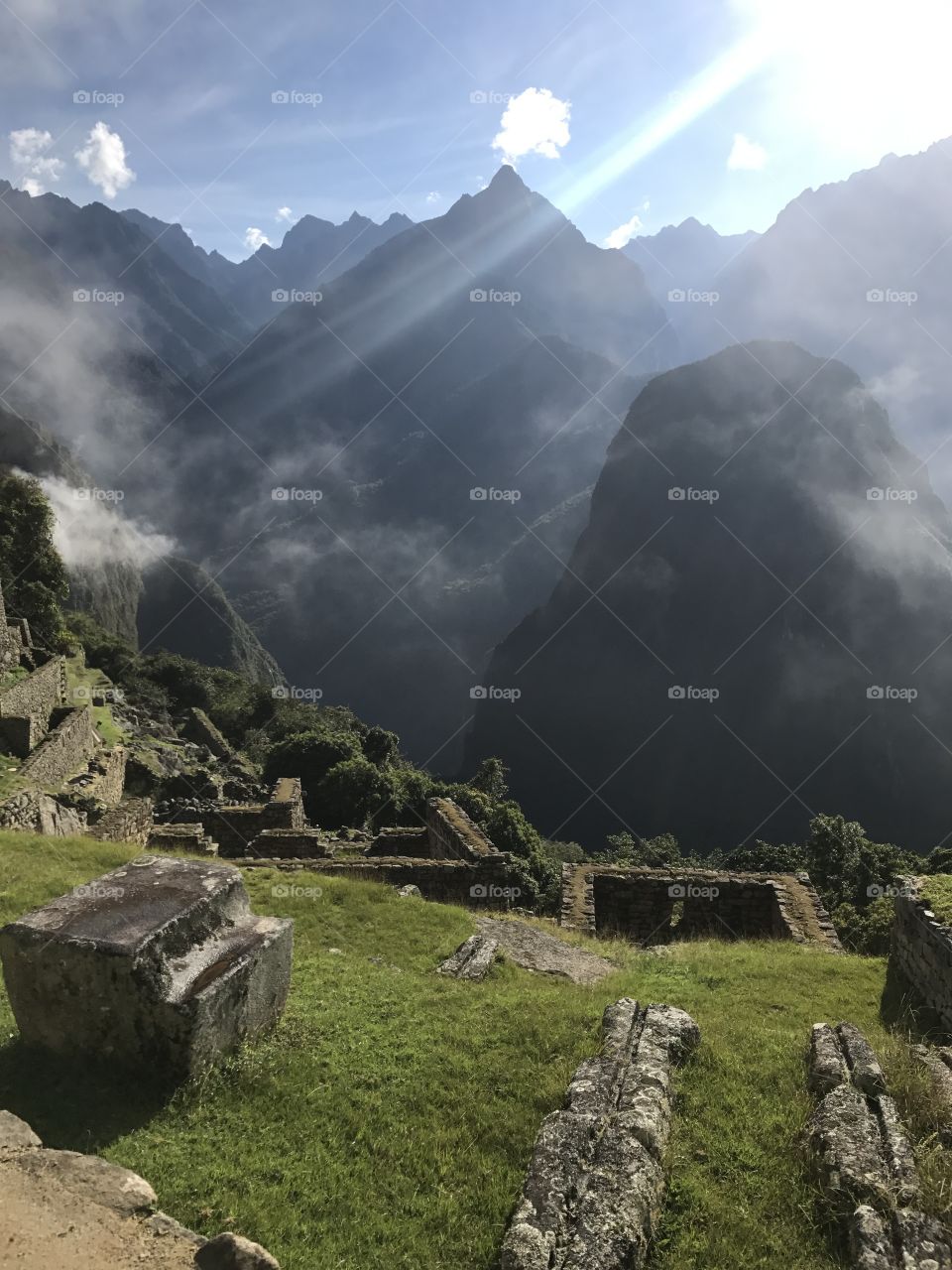 Fog begins to lift off of Machu Picchu, Peru. 