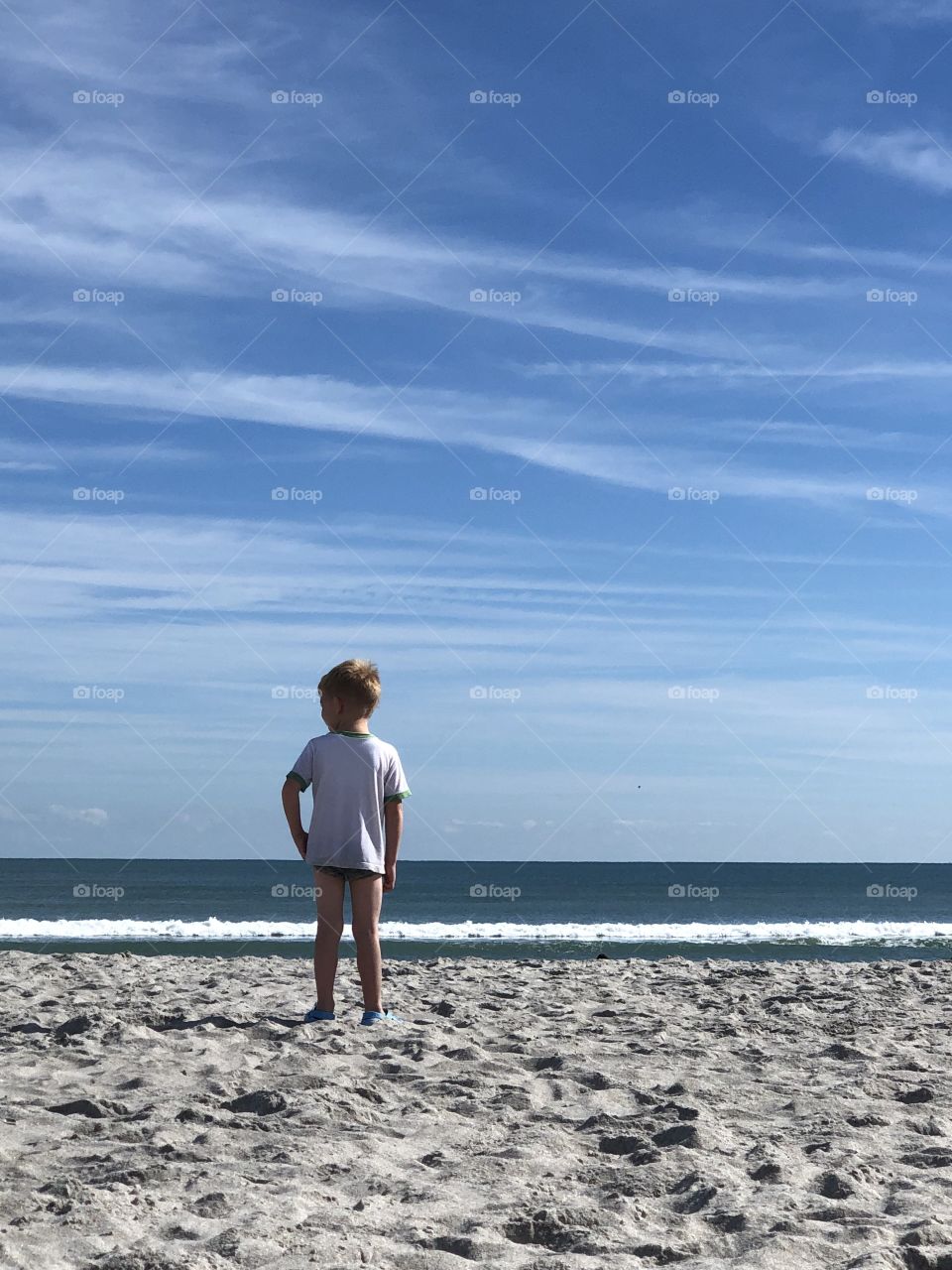 Boy watching the ocean