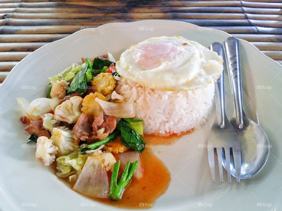 Vegetable fried rice with fried egg in a plate