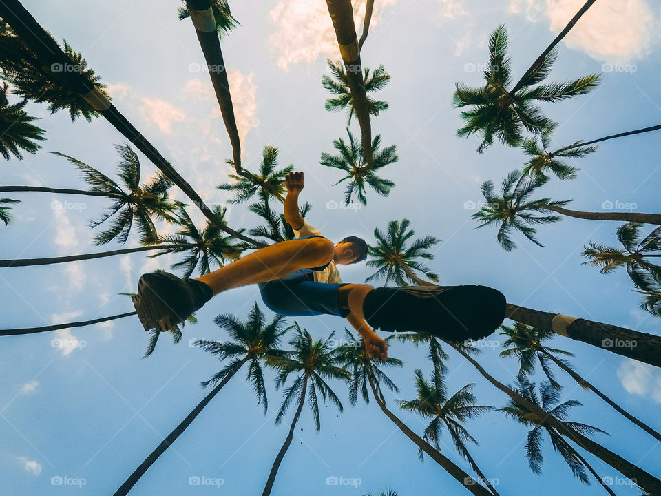 Jump shot in the famous palm trees in Waikiki Beach, Hawaii. You can't compare Hawaii and it has beautiful palm trees. I love jump shot photography. everytime I travel I had mandatory shot for jump shot and the palm trees give more illusion