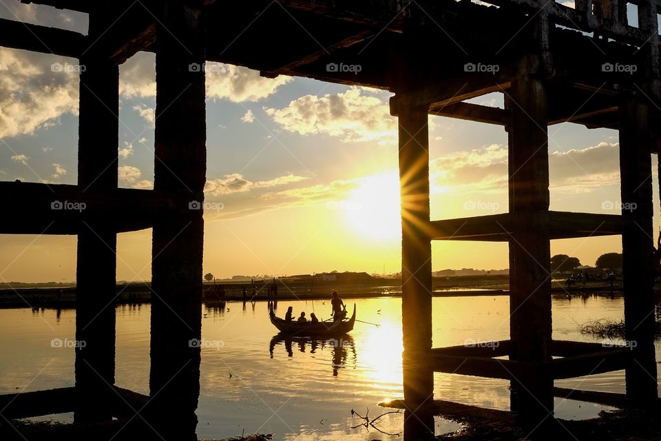 Boat silhouette under the bridge