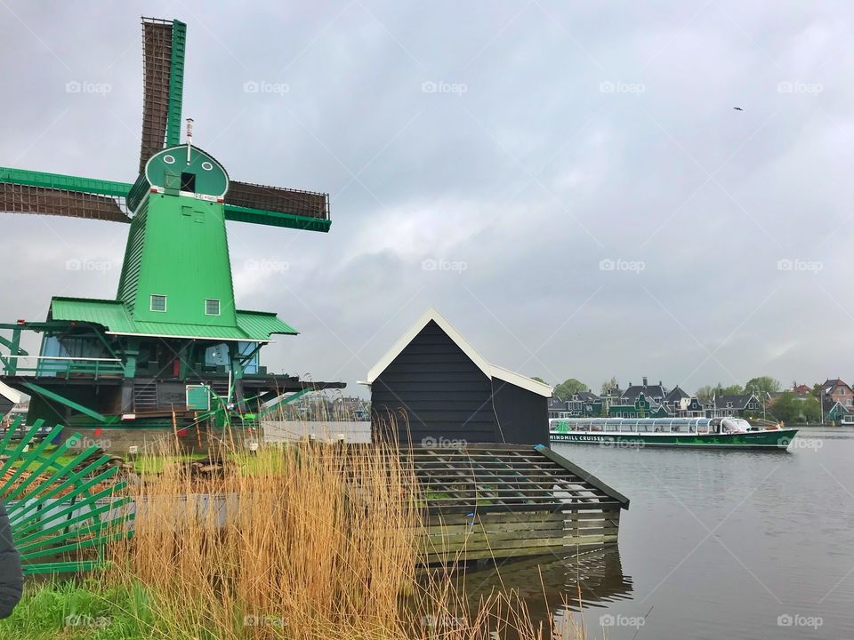 Historic windmill and a boat in the village Zaanse Schans, Holland 
