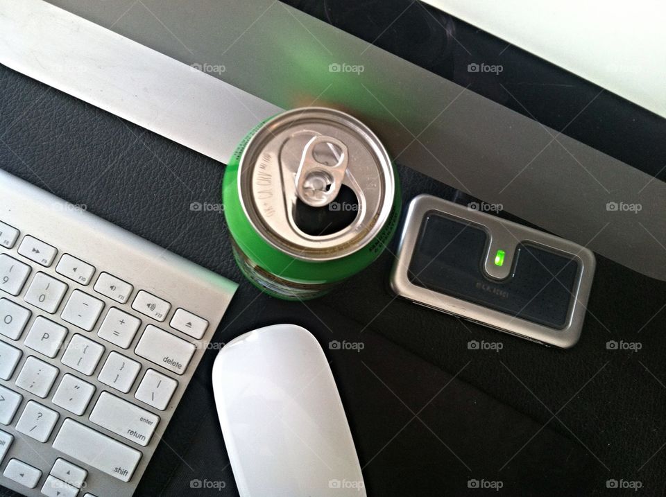 Overhead view of desktop . Computer and can of beer or soda