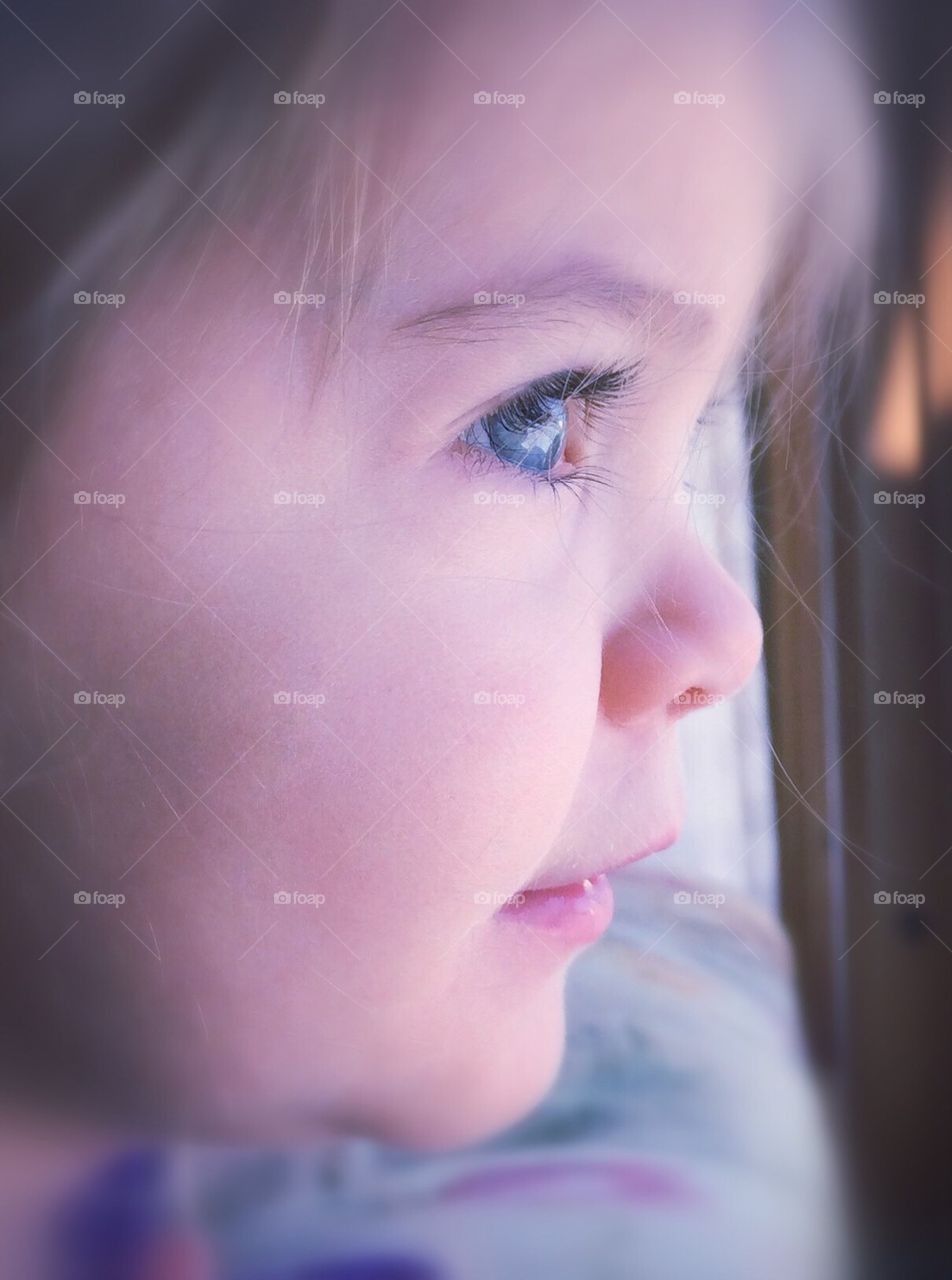 Profile of girl looking out the window