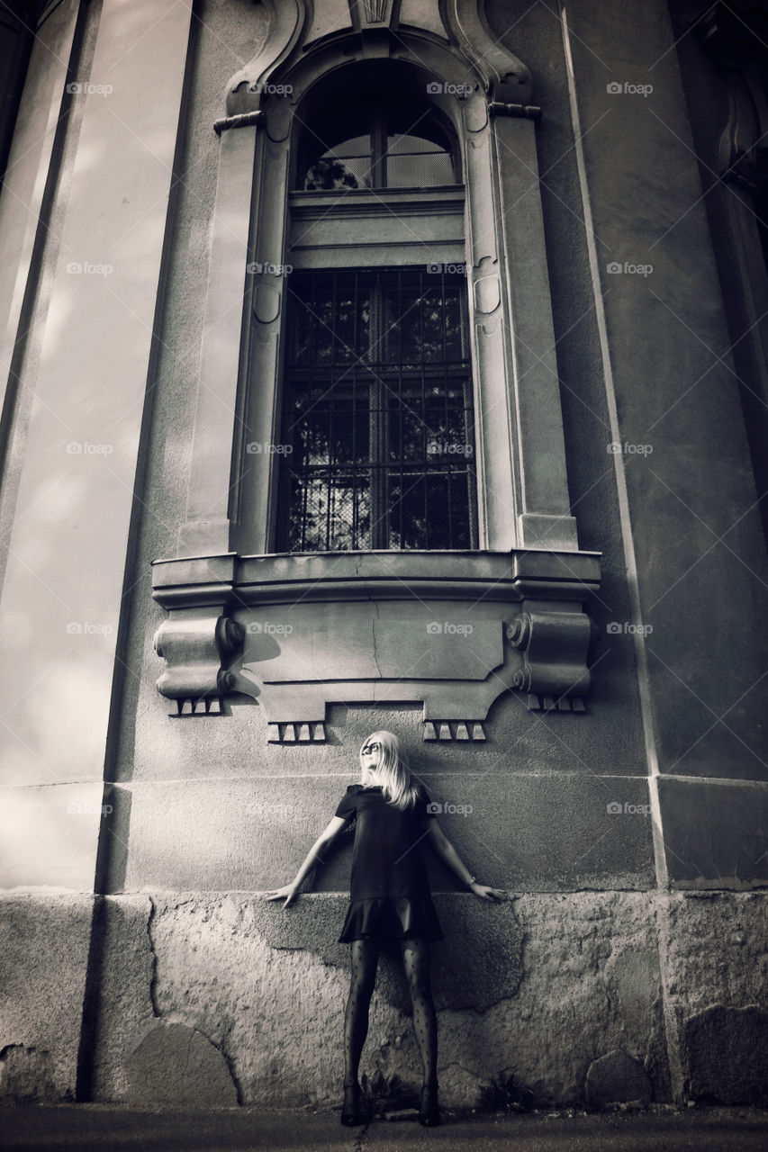 Woman standing under the big window