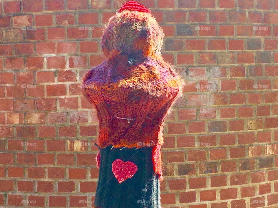 Colorful yarn &a brick wall