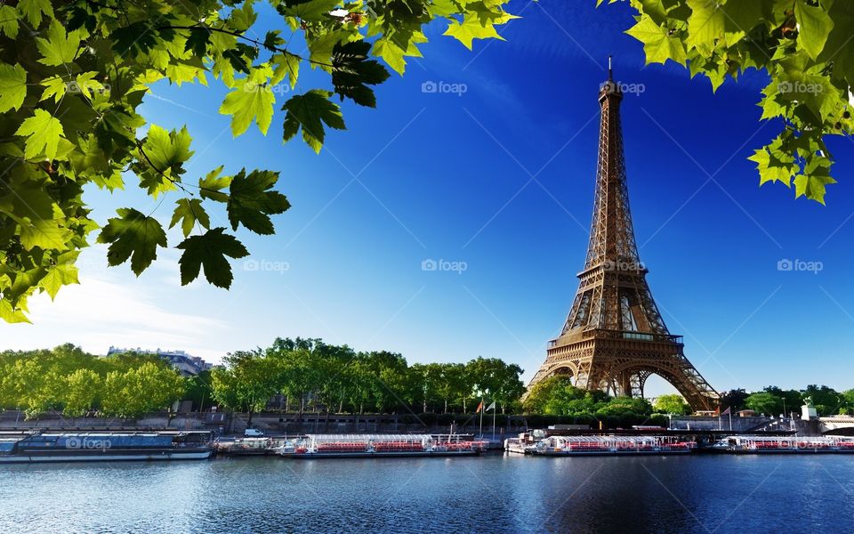 Eiffel Tower with boats on Seine river in Paris, France
