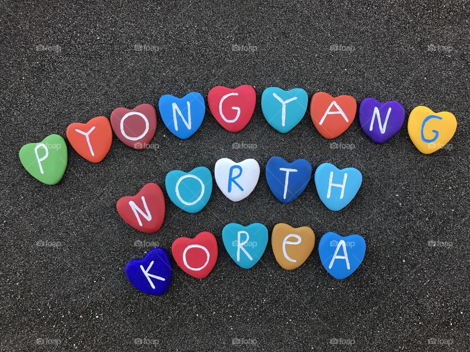 
Pyongyang, ‪평양, capital city of North Korea with colored heart stones over black volcanic sand

