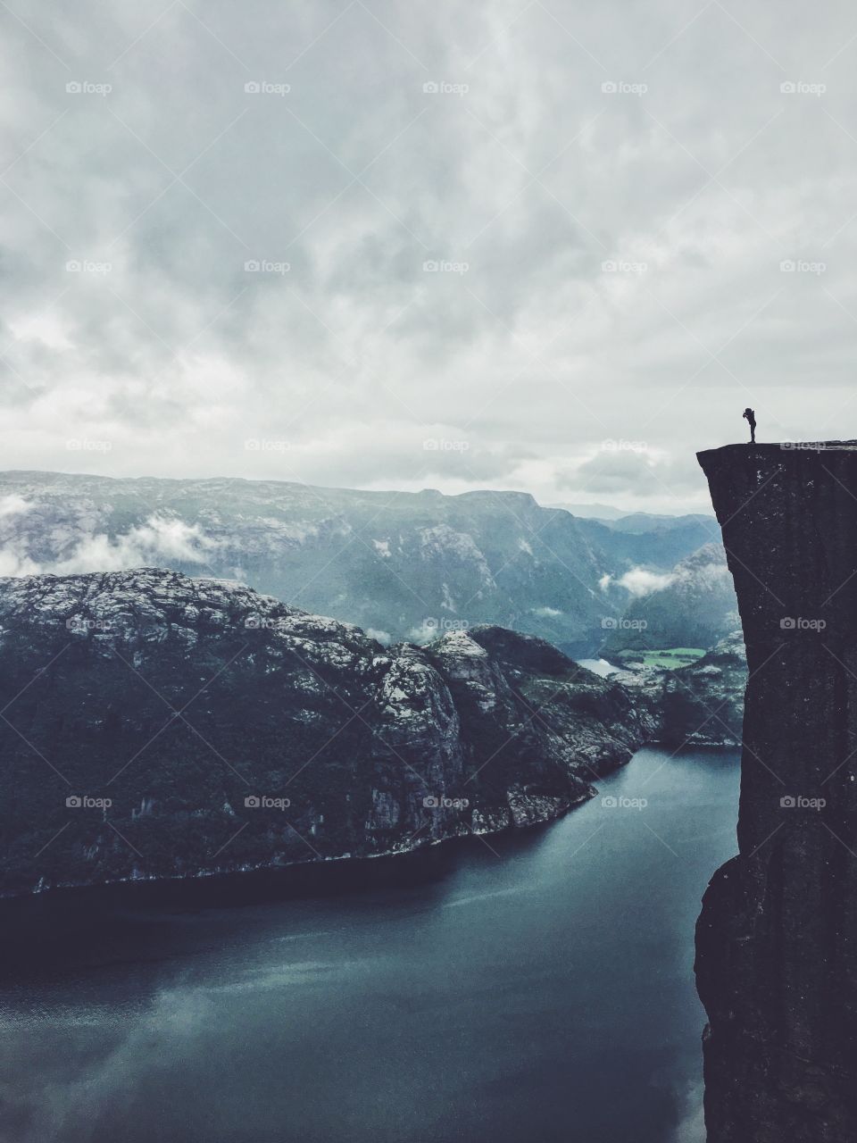 Distant view of person standing on rock