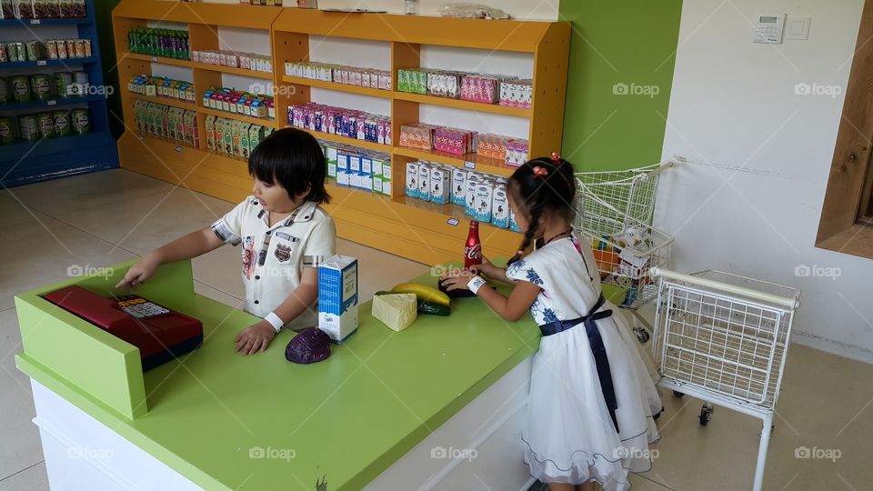 Kid at supermarket. kids acting as adult really life situation