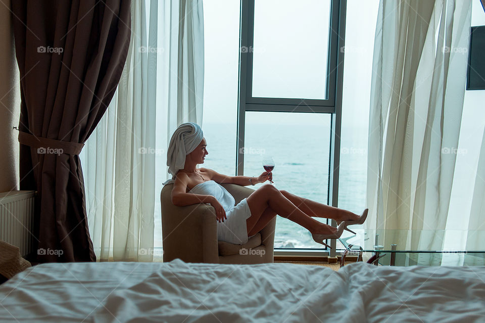 girl at the hotel holds a glass of wine