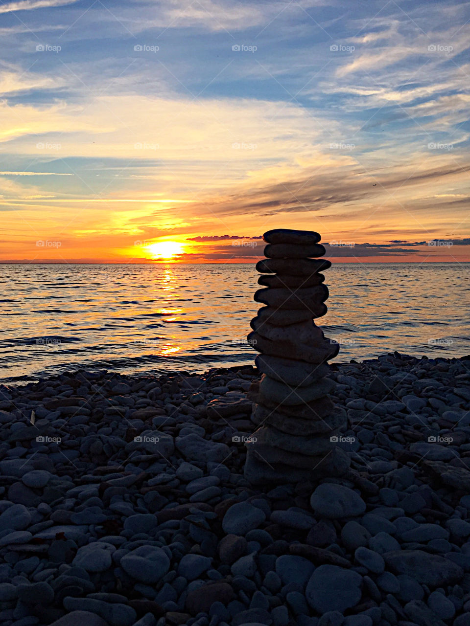 Piling up stones at sunset!