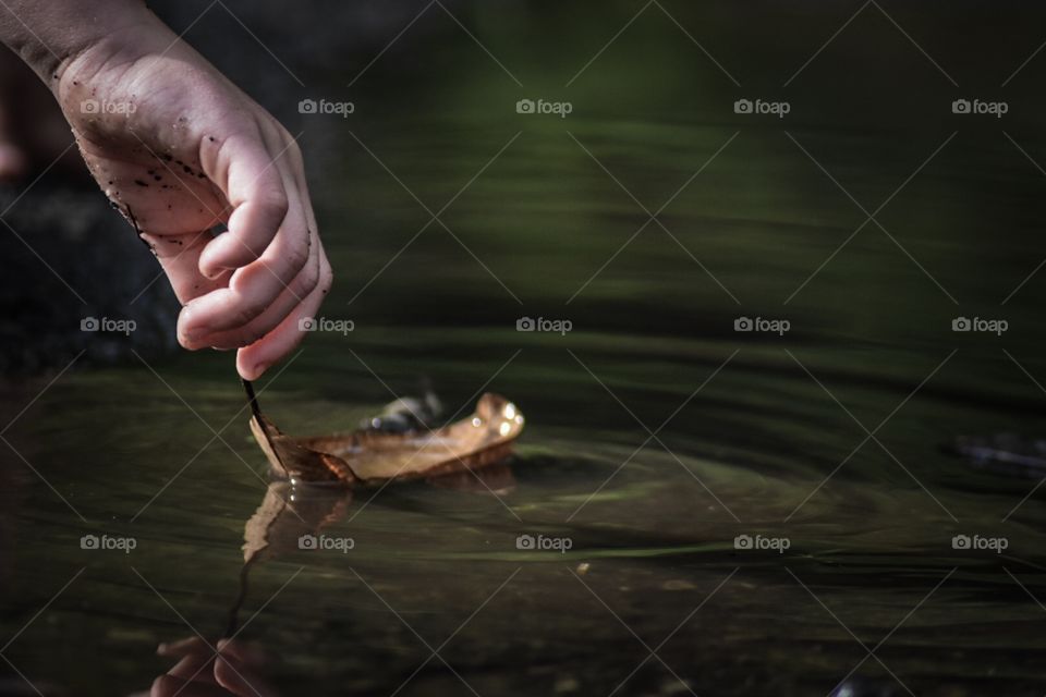 Playing with a leaf in a puddle 