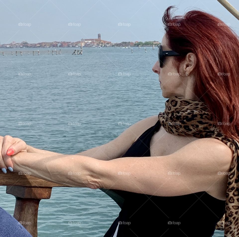 Senior Caucasian women looking out on a sailboat