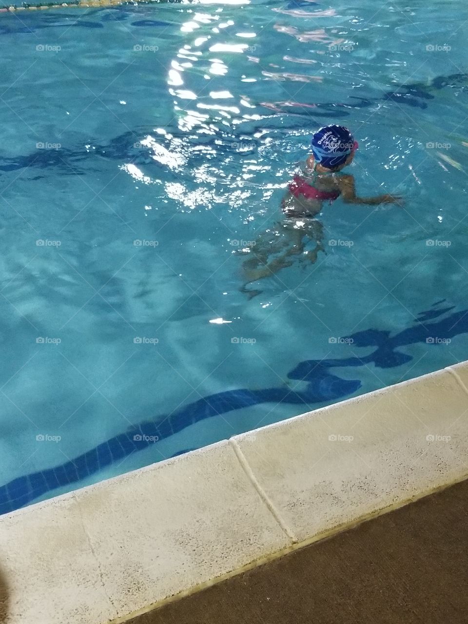 child swimming in pool