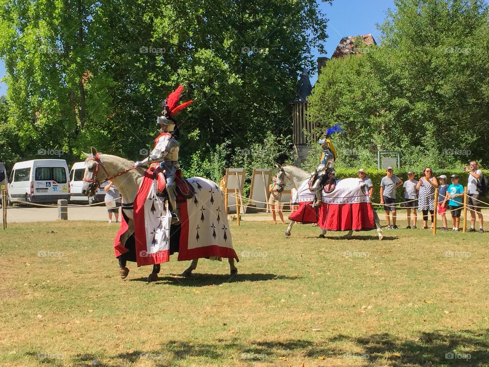 Medieval knight riding a horse on jousting festival