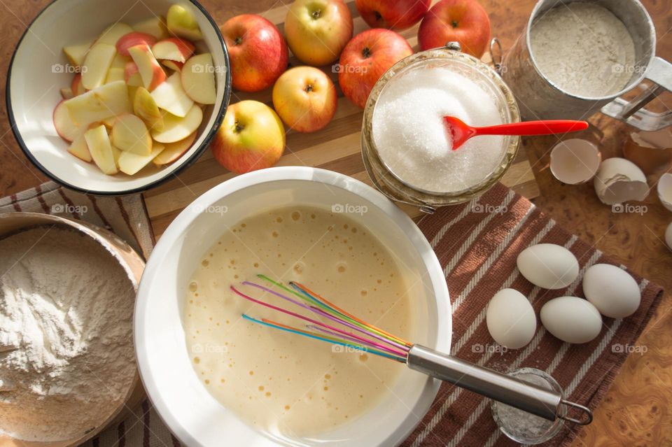 Making homemade puffed apple pie with eggs, sugar and flour.