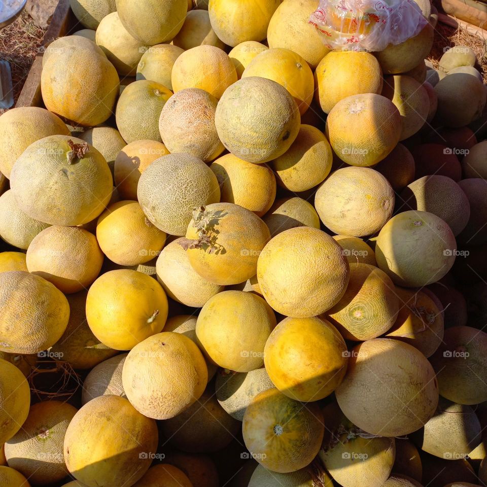 A pile of melons ready to be sold or marketed