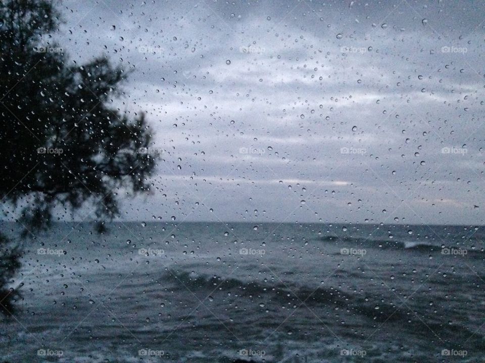 Looking through rainy window on the sea 