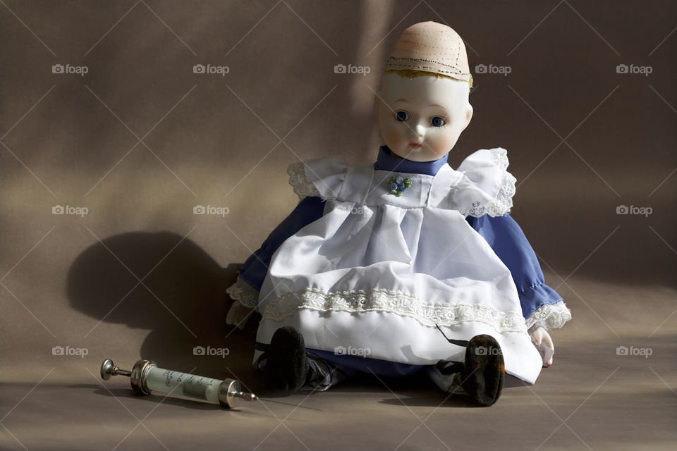 Old doll and cannula