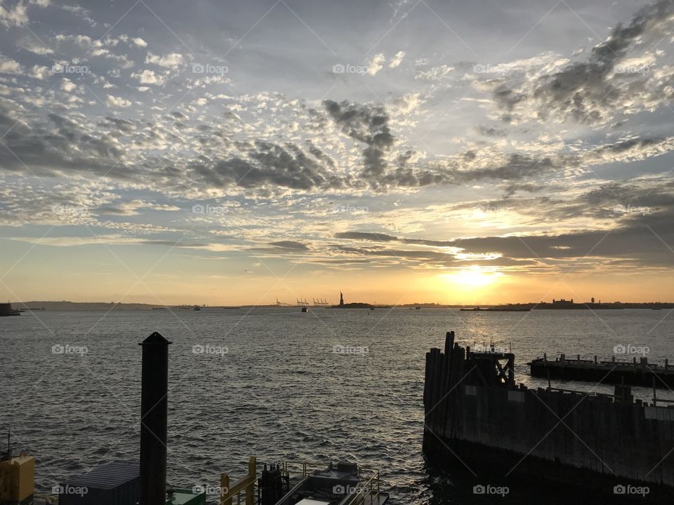 Gorgeous picture of a New York sunset. You can also see the Statue of Liberty in the background:)