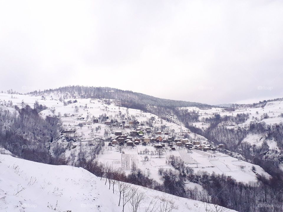 a Bosnian village in snow-covered hills