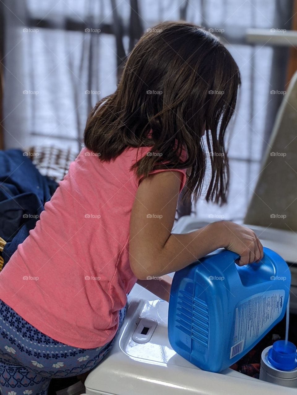 child doing the laundry as a chore