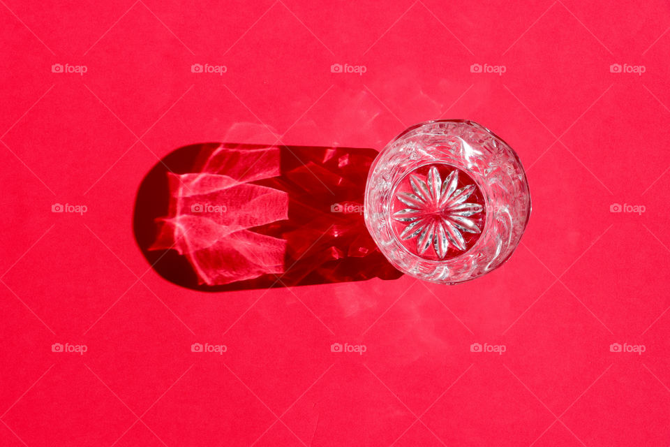 Crystal glass on the red background