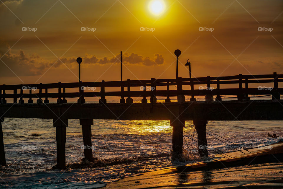 Sunset on a pier on the beaches of the Caribbean