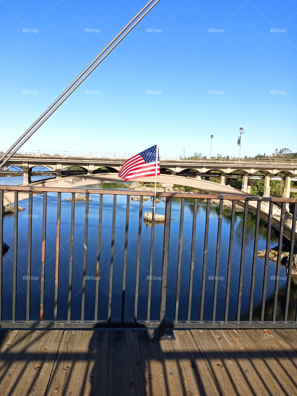 outdoors, standing on a footbridge