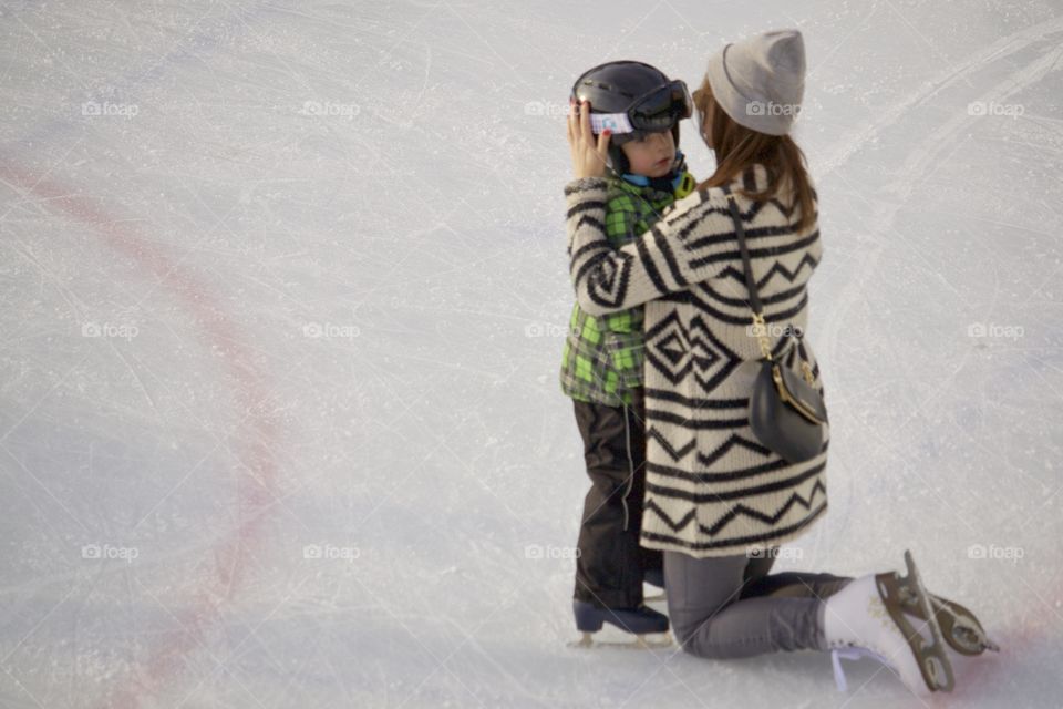 Mom and kid on ice rink