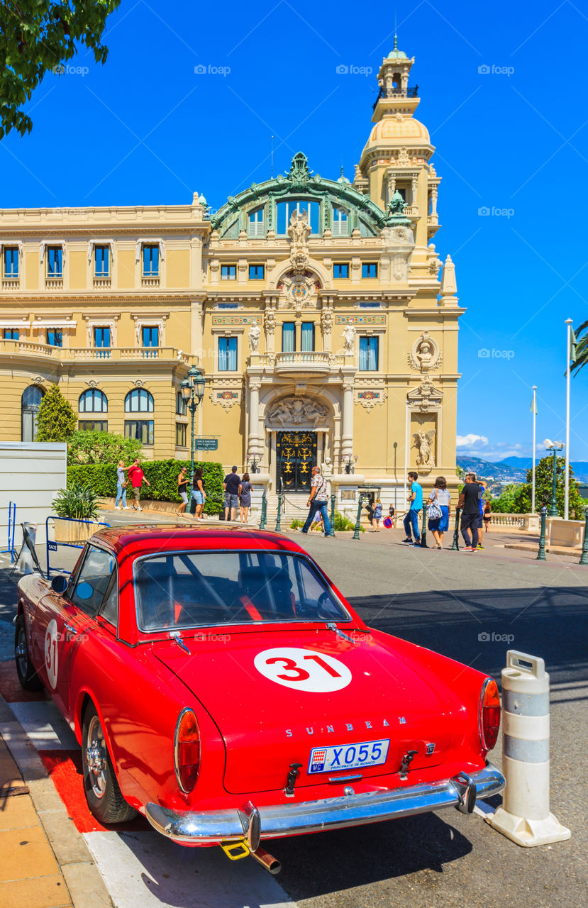 Red car in front of casino. Red retro car, sunbeam- tiger number 31 parking by street in front of casino Monte Carlo, Monaco