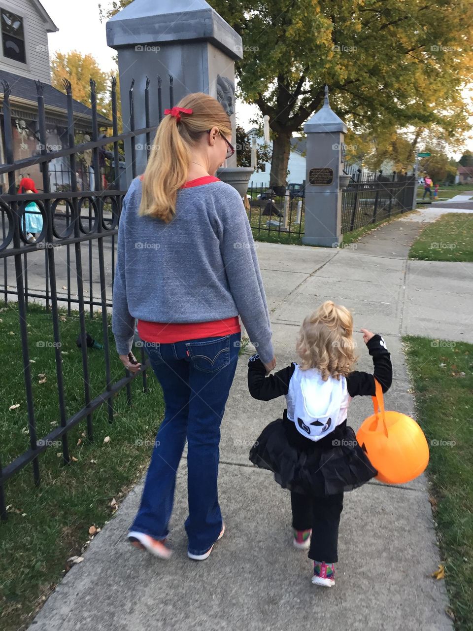 Mother and daughter going out for trick or treat on Halloween 