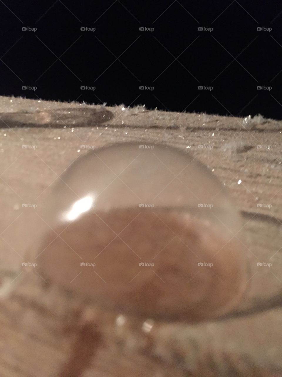 A frozen soap bubble turns into a solid can reflect light and it makes its own shadow