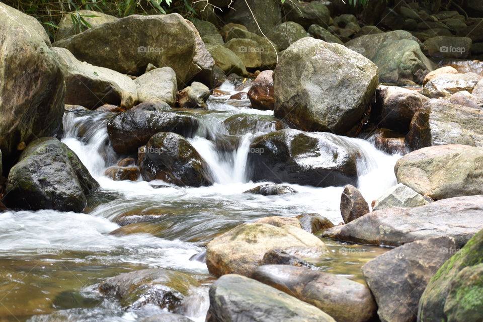 water flows through stones