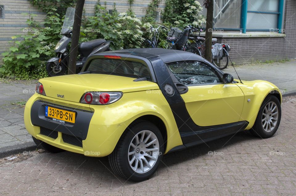 A Yellow Smart Car At Amsterdam The Netherlands 20-5-2024